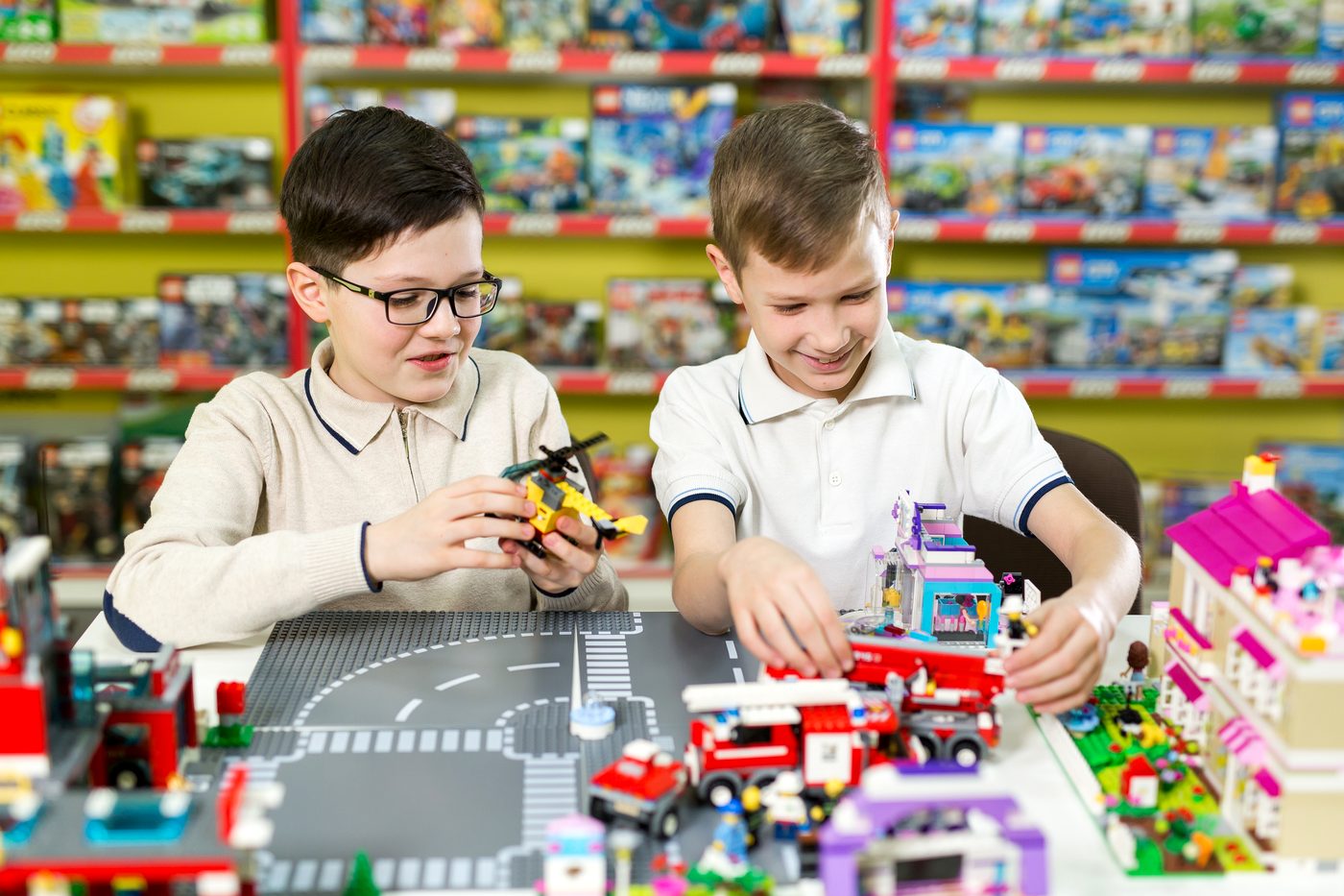 Children building brick sets in a toy store